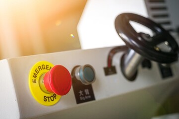 Large red emergency stop button for operating equipment and machines at the production site of the plant. Emergency system for shutting down machines to avoid accidents. Selective focus