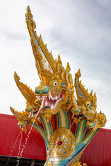 Fototapeta na wymiar the gigantic Phaya Nak statue in Wat Saman Rattanaram in Chachoengsao Thailand, which is famous for image of bright pink Ganesha.