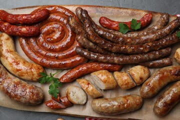 Set of different tasty snacks and beer on dark grey table, top view