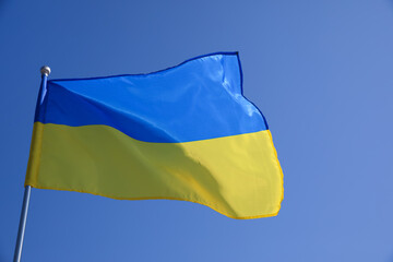 National flag of Ukraine fluttering on sunny day outdoors