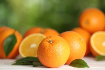 Fresh ripe oranges on white table against blurred background. Space for text
