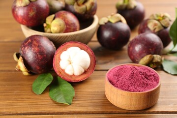 Fototapeta na wymiar Purple mangosteen powder and fruits on wooden table