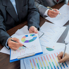 Group professional business people person working together to analyze in office, work together to discuss company financial statistics report, brainstorm ideas, and graph datum documents on the table. - obrazy, fototapety, plakaty