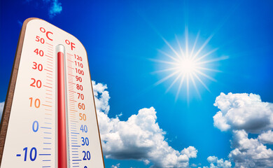 low angle view Thermometer on blue sky with sun shining in summer show higher Weather, concept global warming, climate change