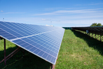 Solar batteries power station located in a field. Renewable energy clean and good environment.