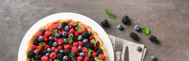 Tasty berry pie on grunge table, top view