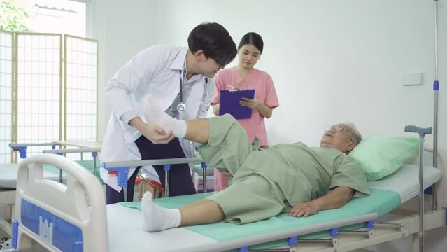 Old elderly Asian patient or pensioner, a nurse and a doctor smiling, doing exercise, working out  in nursing home in hospital.Senior people lifestyle activity recreation. Health care physical therapy