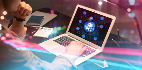 Businessman working on laptop in office. RPA concept