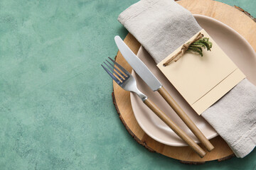Simple table setting with floral decor on green background