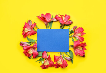 Composition with blank card and alstroemeria flowers on color background