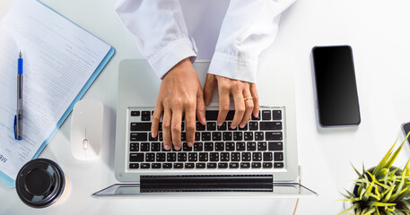 Nurse working using computer browsing internet, Closeup hands female doctor wear uniform in...