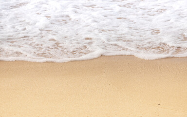 Fototapeta na wymiar Ocean Waves Washing Onto Sandy Shore Beach