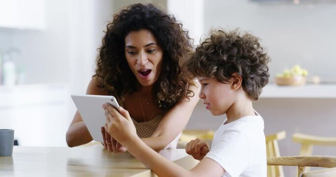 Mother and son with tablet playing games, talking and bonding while searching interactive education activity on tech. Slow motion of parent and adorable, cute or curious boy enjoying home family time