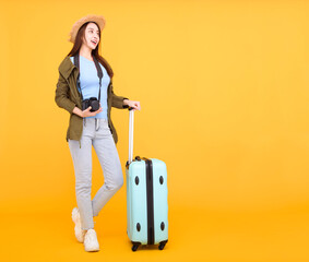 Happy young woman with  luggage and camera isolated on yellow background ,autumn,travel concept.