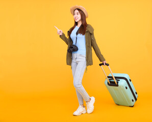 Happy young woman with  luggage and camera isolated on yellow background ,autumn,travel concept.
