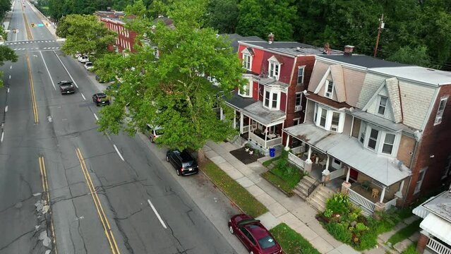 Homes in USA. Rental properties along urban street in America. Aerial establishing shot.