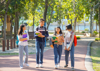 Fototapeta premium Asian teenagers student walking together in the park after school, Education concept.