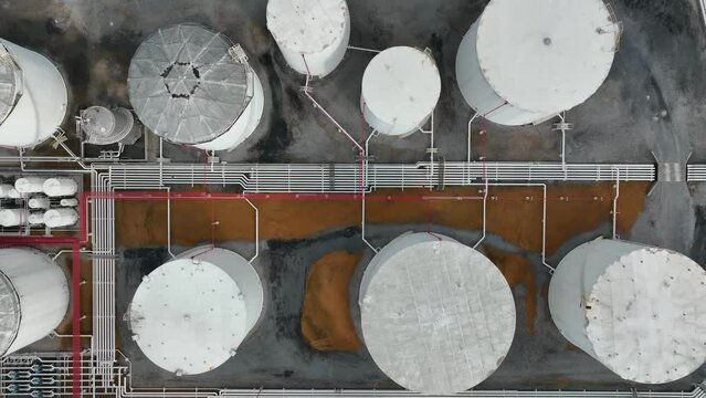 Pipeline distribution to holding tanks for bulk fuel. Fossil fuel theme. Aerial truck shot.