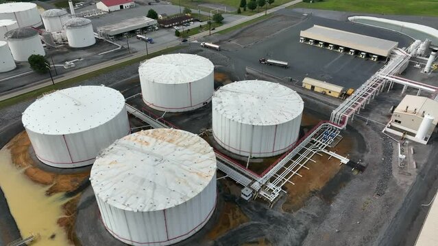 Large above ground tanks store oil and gas. Energy sector in USA. Aerial of pipeline system.