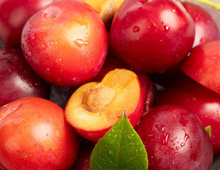 Plate of fresh ripe plums on table.