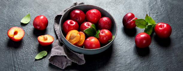 Fresh red plums in plate.