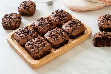 dark chocolate brownies topped by chocolate chips