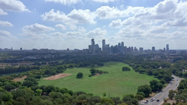 Austin Texas Skyline Aerial Drone pullback shot on sunny day, Texas austin from zilker park