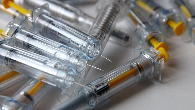 Bunch of injection syringes as vaccinations doses and booster vaccination dose for covid-19 vaccine prevention and medical treatment with experimental drugs pharmaceutical wealth with 3rd mrna vaccine