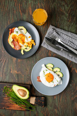 English breakfast - toast with bacon, avocado and egg on a plate. Healthy food. Top view