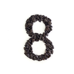 Number 8 made from sunflower seeds. Alphabet made from sunflower seeds. White background