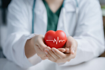 Doctor hands holding red heart in concept healthcare,wellbeing, organ donation and insurance life....