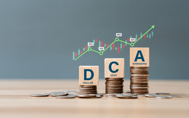 DCA word on a wooden cube on coins in idea Dollar Cost Averaging investment strategy, Saving stock...