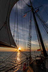 sailing trip on the baltic sea with a moody sunset  - obrazy, fototapety, plakaty