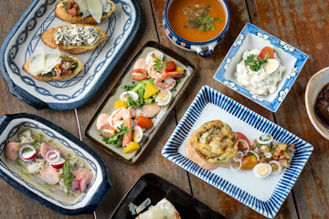 selection of many different tapas on rustic wood table