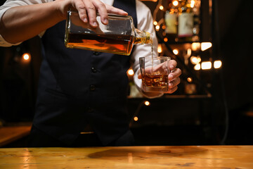 Barman pouring whiskey whiskey glass beautiful night