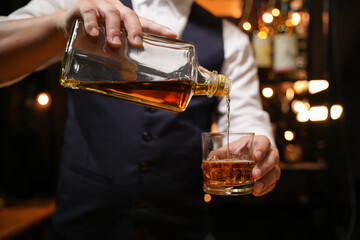 Barman pouring whiskey whiskey glass beautiful night