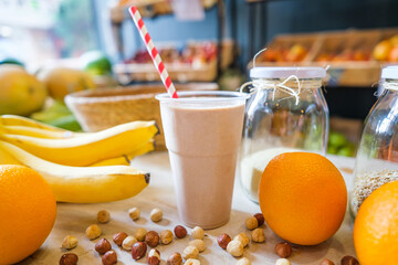 Healthy protein shake on table with fruits and vegetables ingredients around.