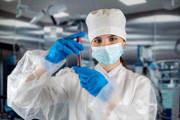 female doctor or an assistant takes a patient's blood sample in the sampling room.