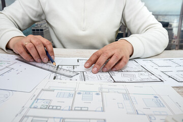 a man working on a drawing to create his home with professional design skills.