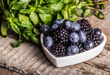 Bowl with delicious fresh berries. Blueberries and blackberries