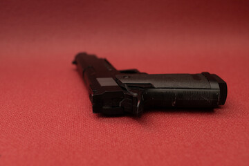 Black gun on red background