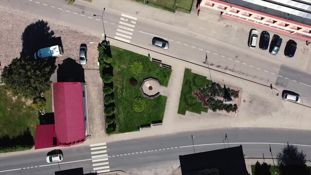 Arial drone shot. Tippy, hallucinogenic image of city square. Drone spinning in circles while descending.