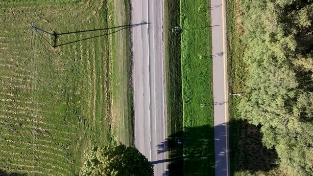 Arial Drone shot over the road and the bike road next to it. Lithuania 2022. Silute.