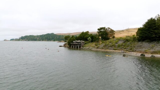 Flying Towards Nice Cottage Design Built On Water At Bahia Tomales, California 