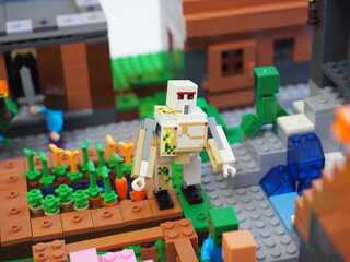 Obraz premium Elements and fragments of Lego village world set. Characters of electronic game Minecraft. Children's designer with small details, developing motor skills and imagination.