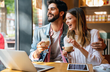 Romantic loving couple drinking coffee, having a date in the cafe.