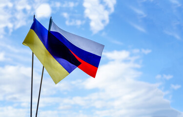 Flag of Russia and Ukraine on blue sky background. Peace and no war