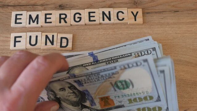 Hand is taking money from emergency fund