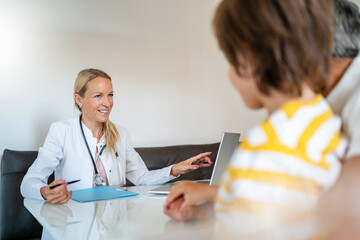 Female doctor with father and son in medical practice