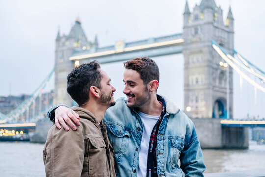 London, United Kingdom, A couple of guys embracing in front of Tower Bridge